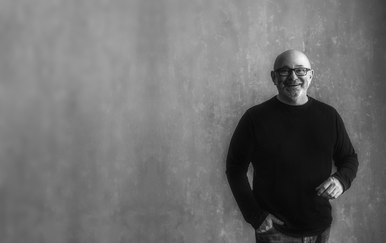 Carl Cummings standing in front of a textured wall